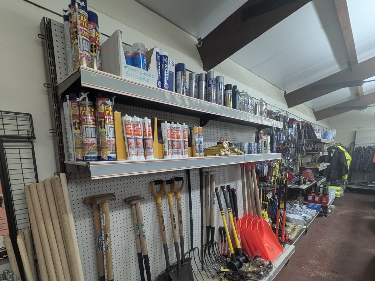 Tools, handles and hardware on the wall of the agricultural supplies store